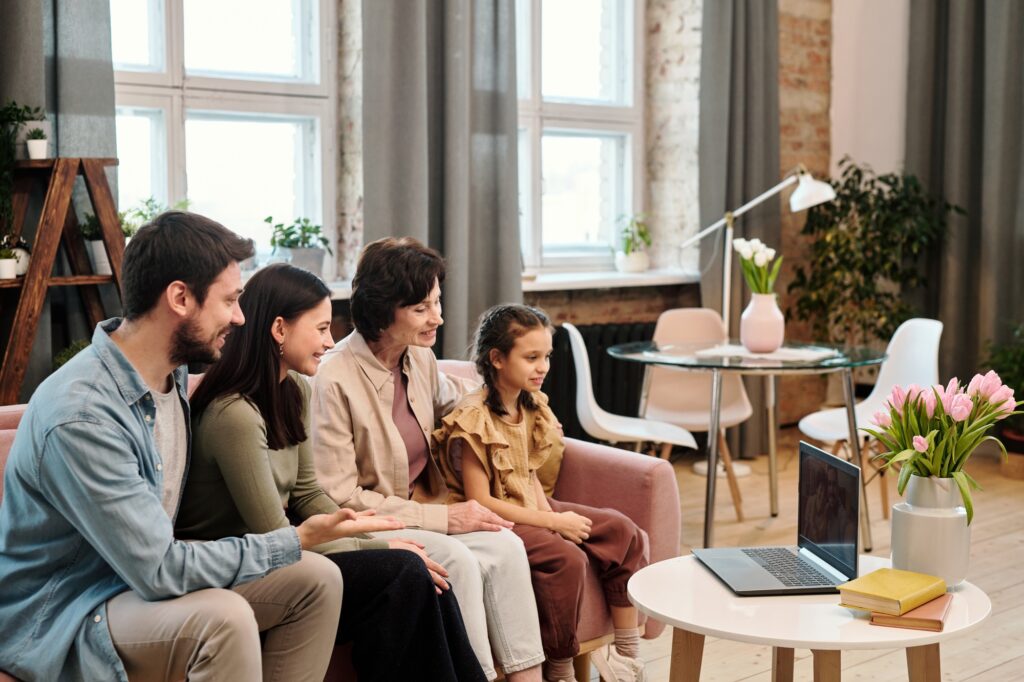 Happy family communicating through video chat in living-room